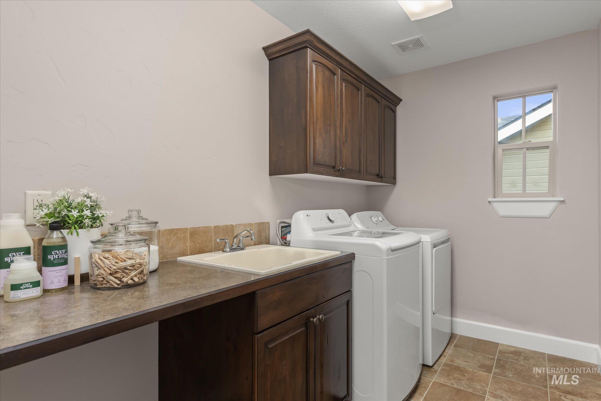 Washroom with cabinet space and independent washer and dryer