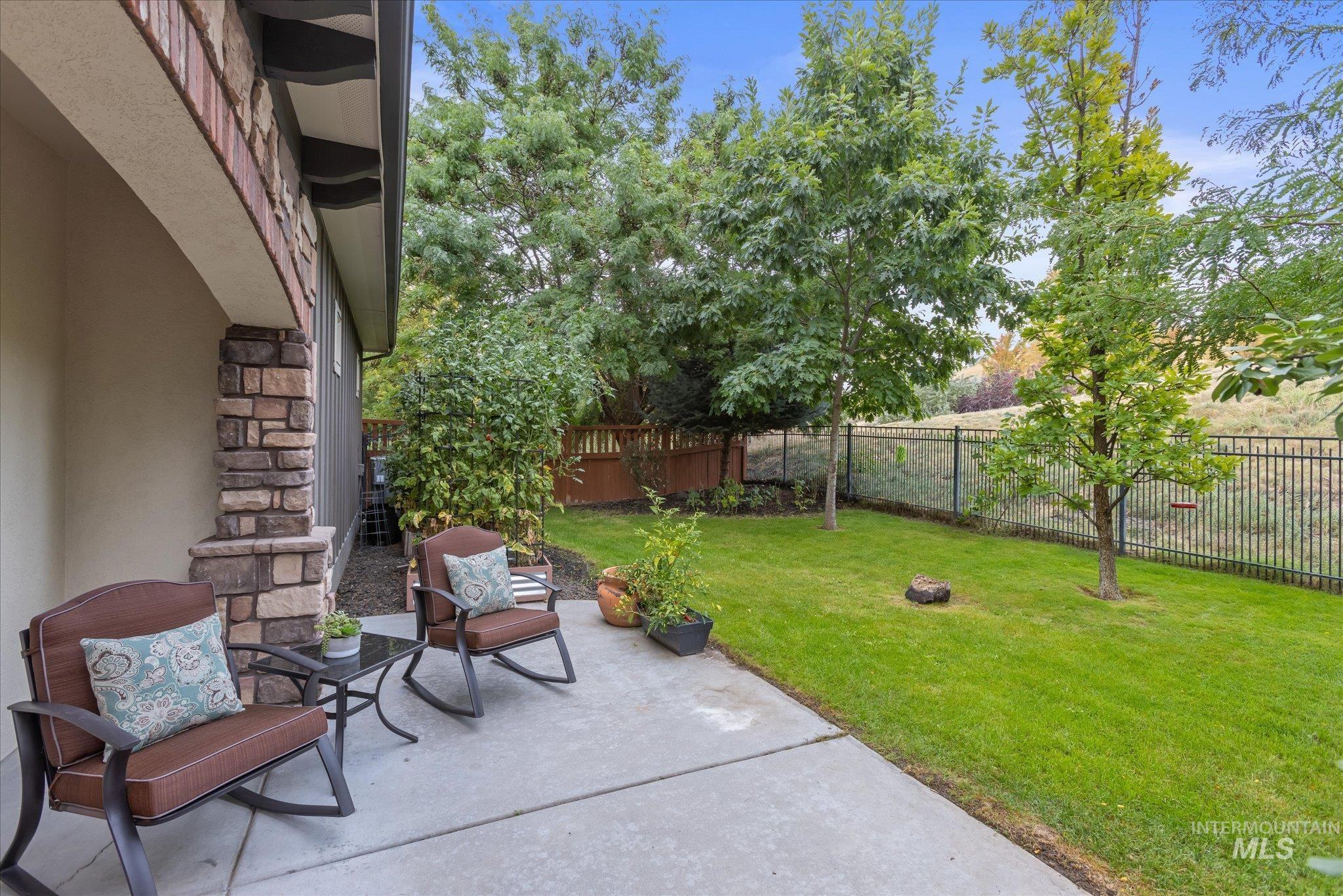 Fenced backyard featuring a patio