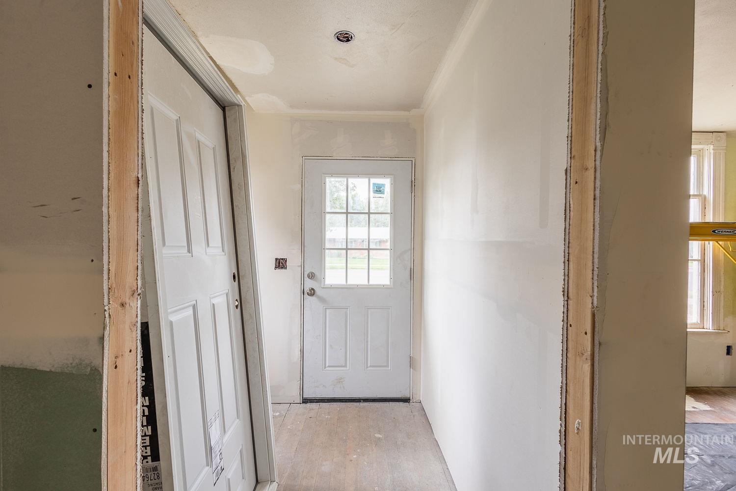 Doorway to outside with wood finished floors
