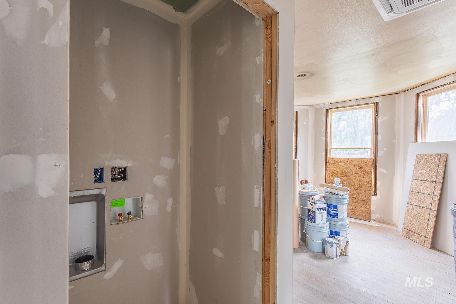 Laundry room featuring washer hookup and wood finished floors