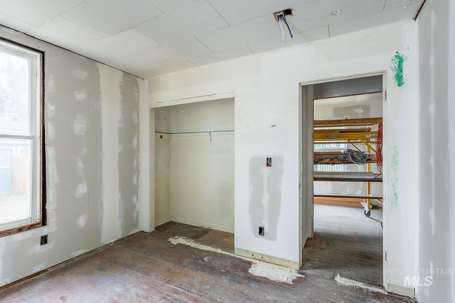 Unfurnished bedroom featuring a closet and wood finished floors