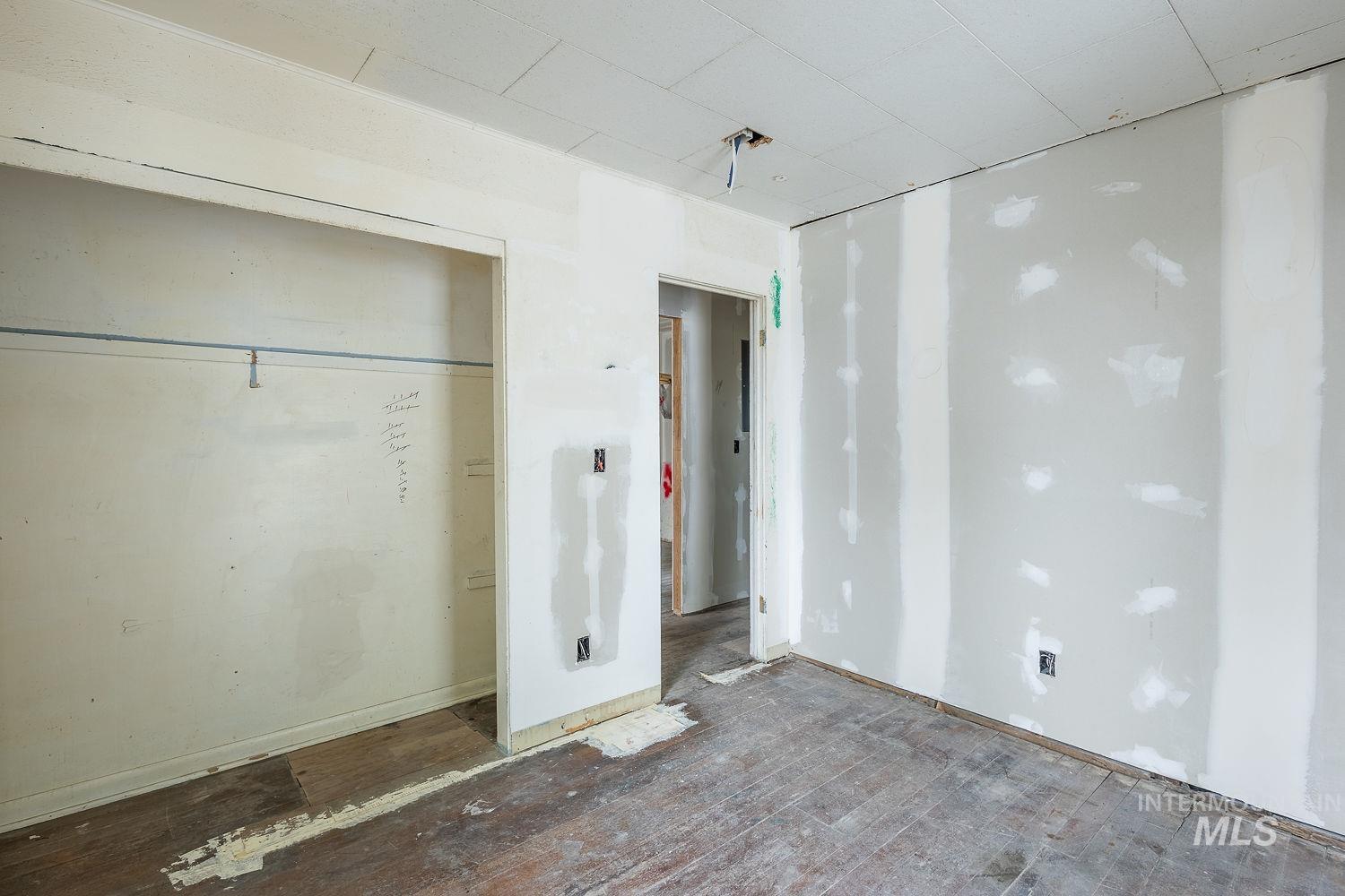 Unfurnished bedroom with hardwood / wood-style floors and a closet