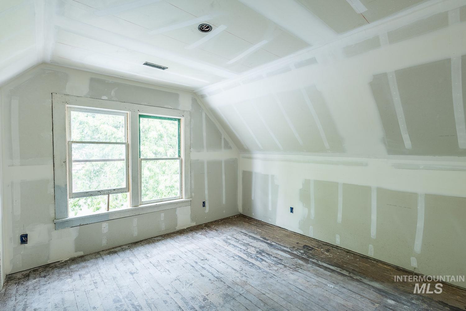 Bonus room featuring vaulted ceiling and hardwood / wood-style flooring