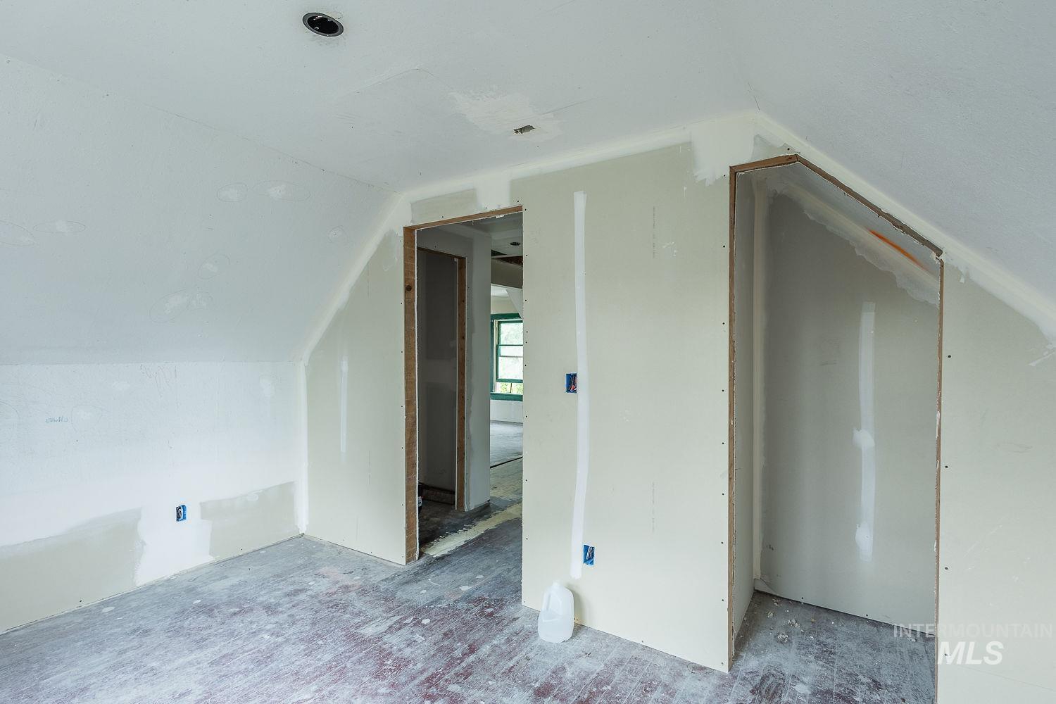 Additional living space featuring lofted ceiling