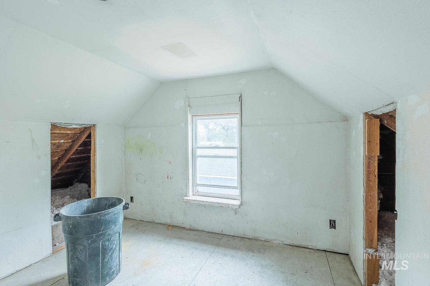 Additional living space featuring lofted ceiling