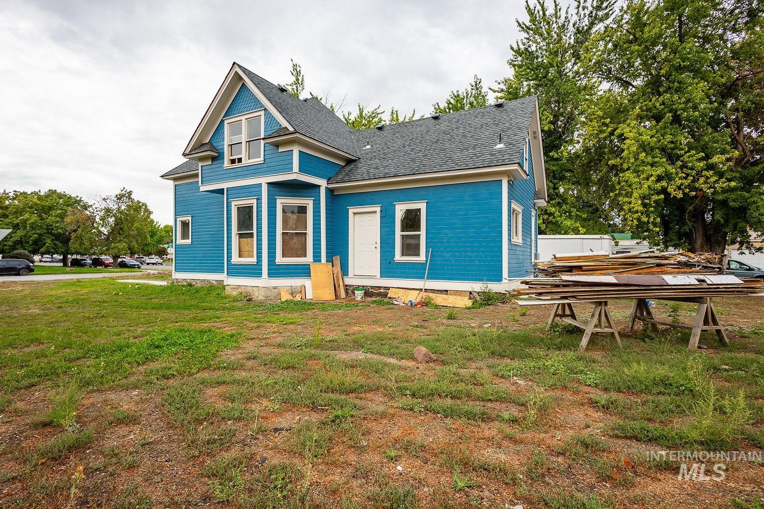 View of front of house with a shingled roof