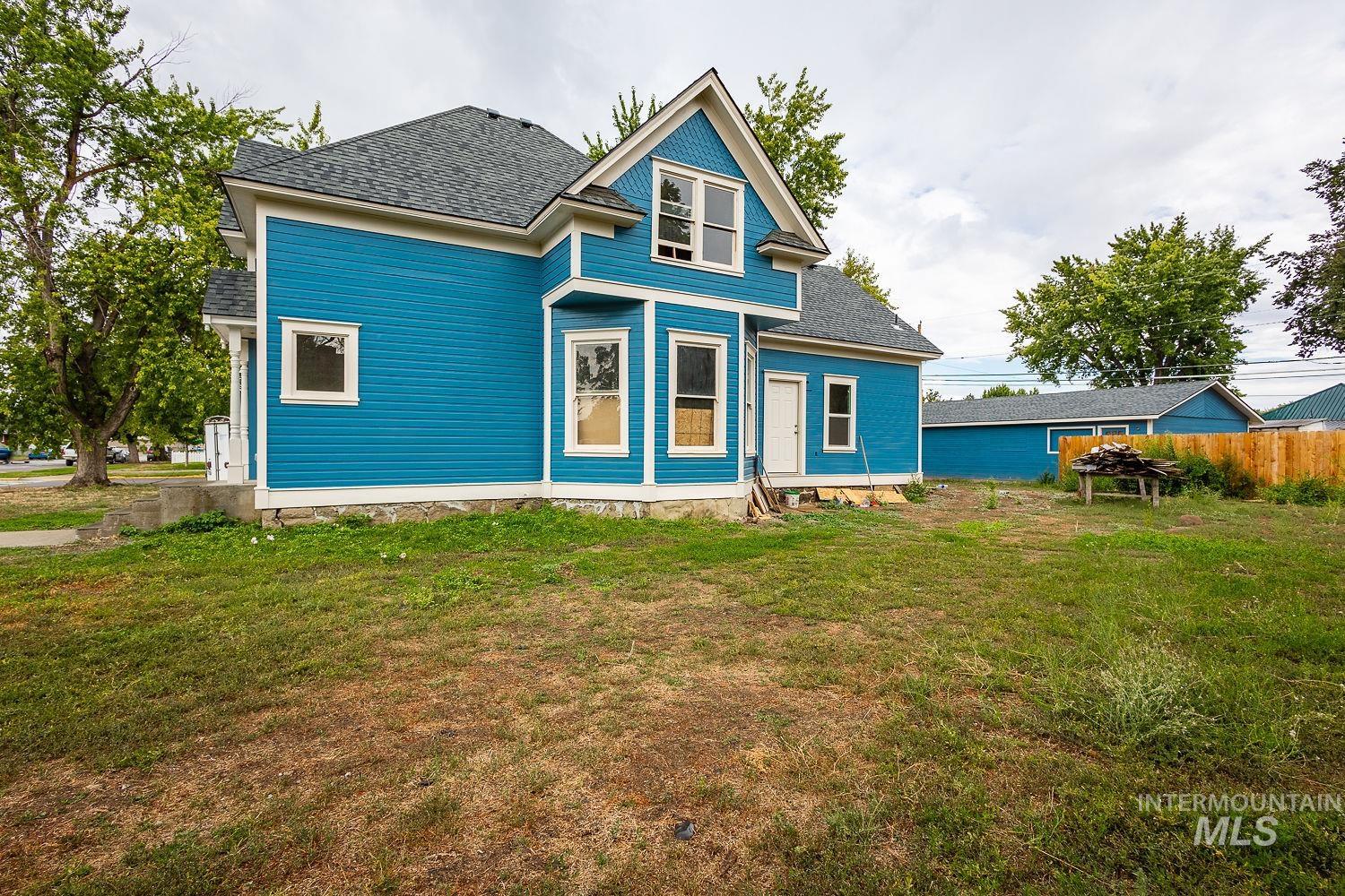 Back of property featuring roof with shingles