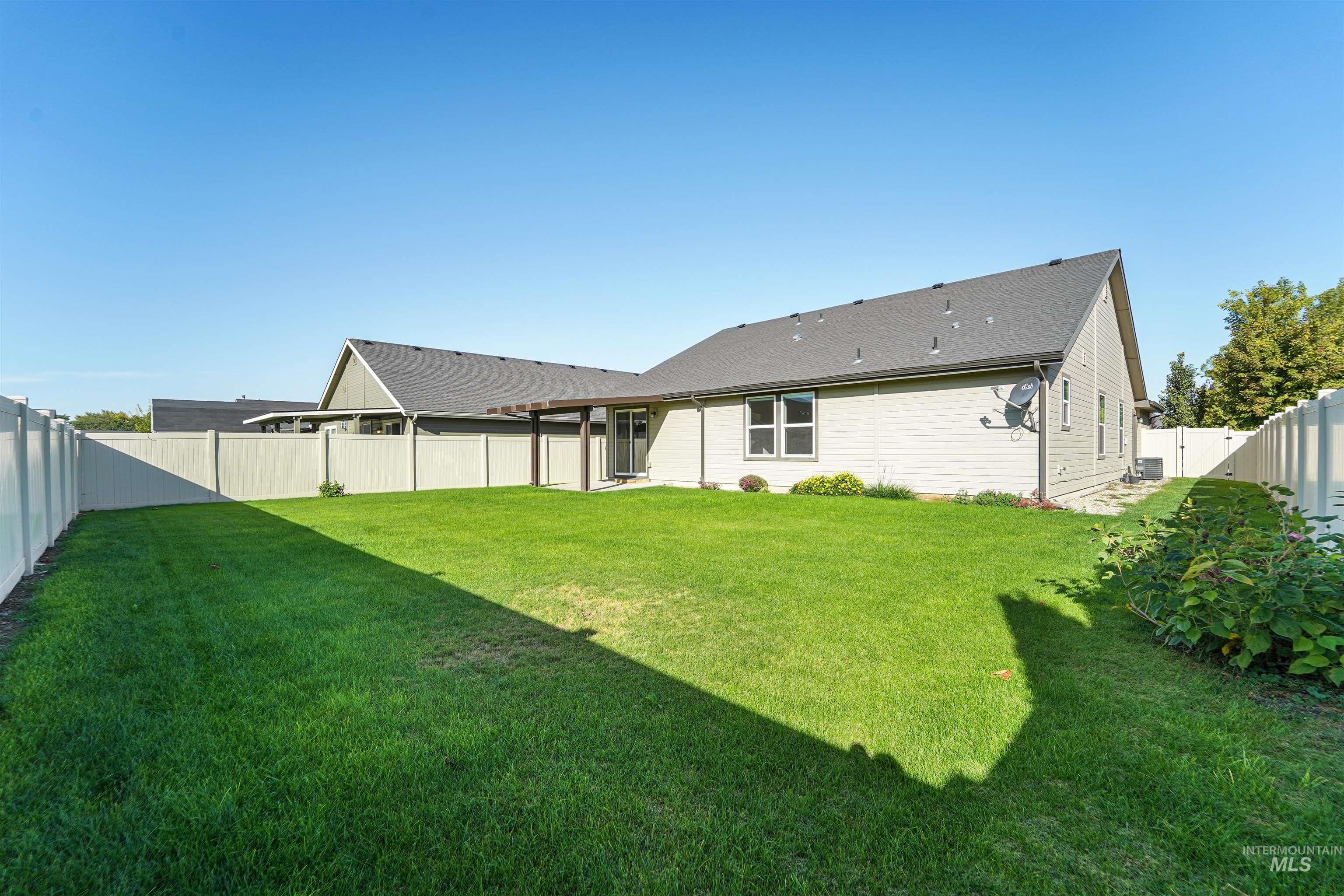 Back of property featuring a fenced backyard and a patio area