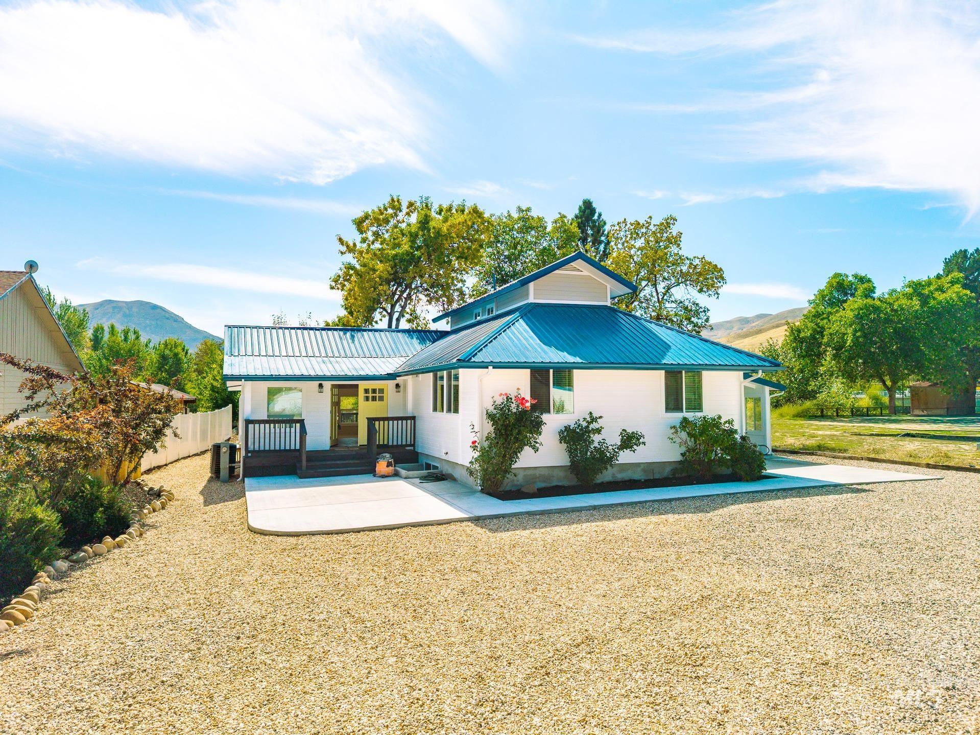 Rear view of property featuring a metal roof and a mountain view