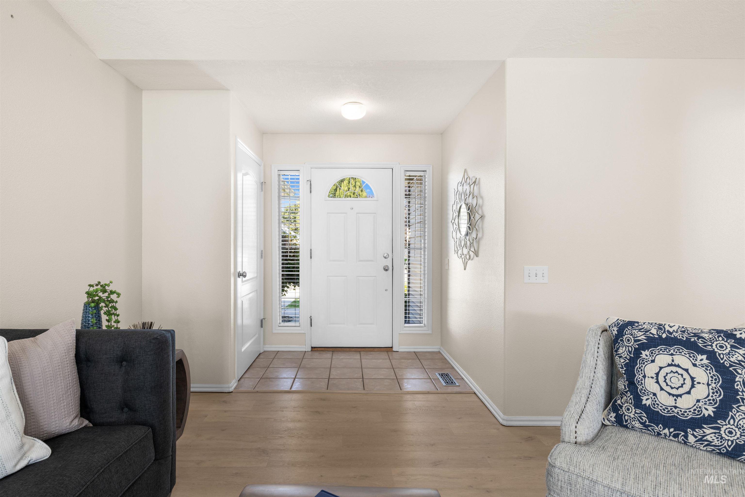 Foyer entrance featuring baseboards and wood finished floors