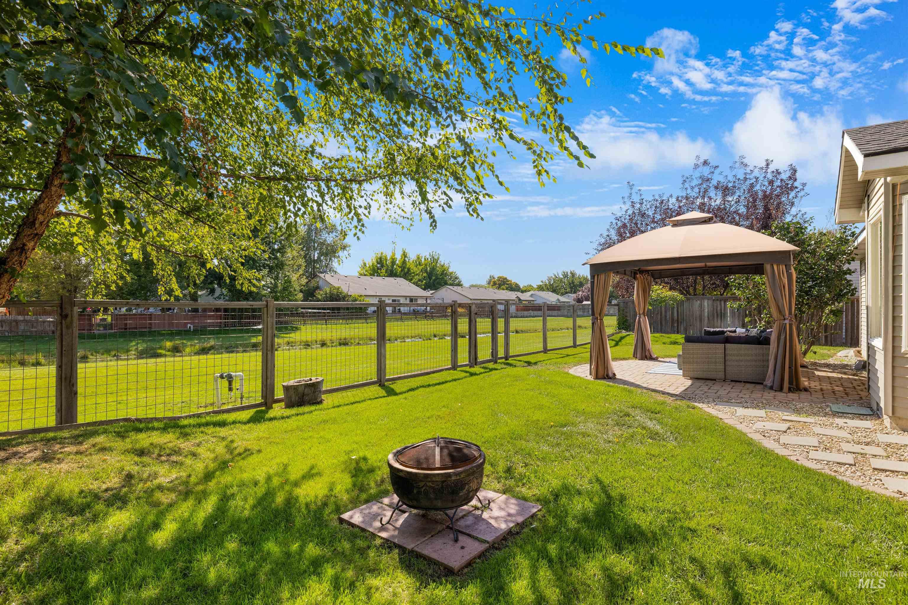 View of yard featuring a gazebo, a patio area, and an outdoor living space with a fire pit