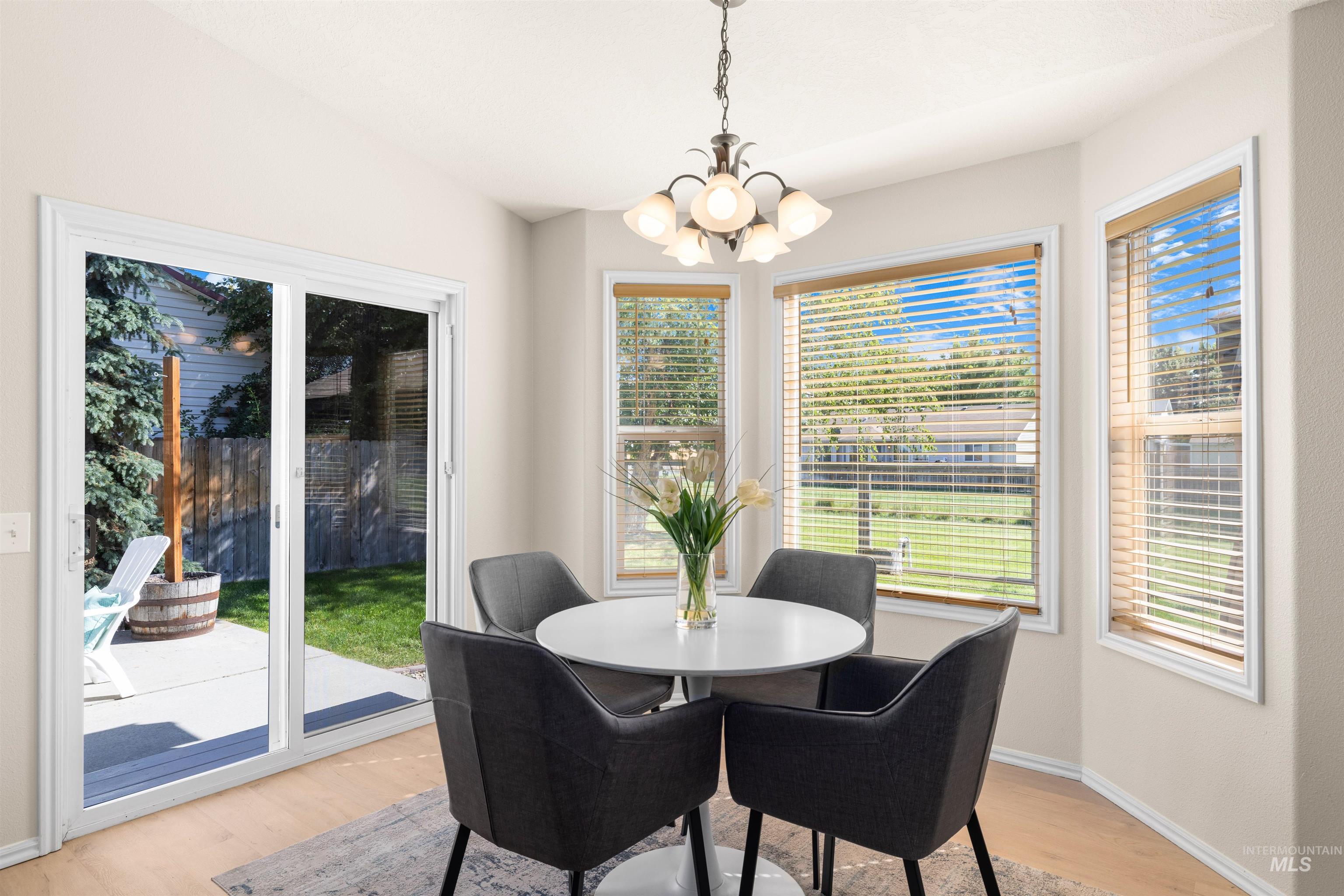 Dining space featuring light wood-type flooring and a chandelier