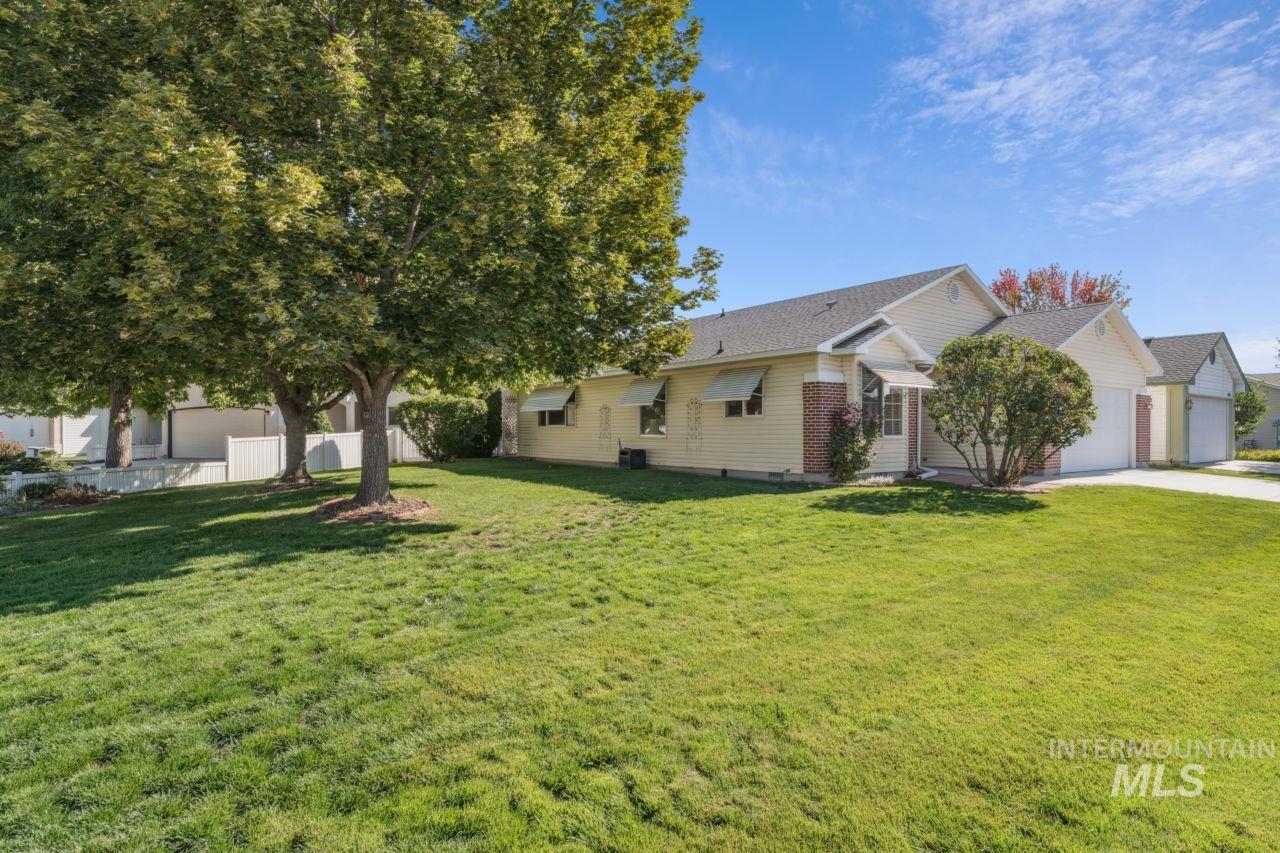 View of front of home with a garage, driveway, and roof with shingles