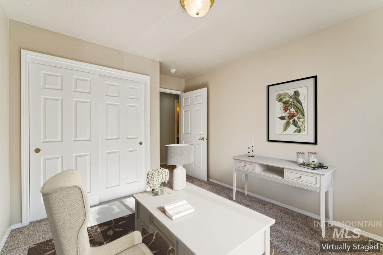 Carpeted office space featuring baseboards