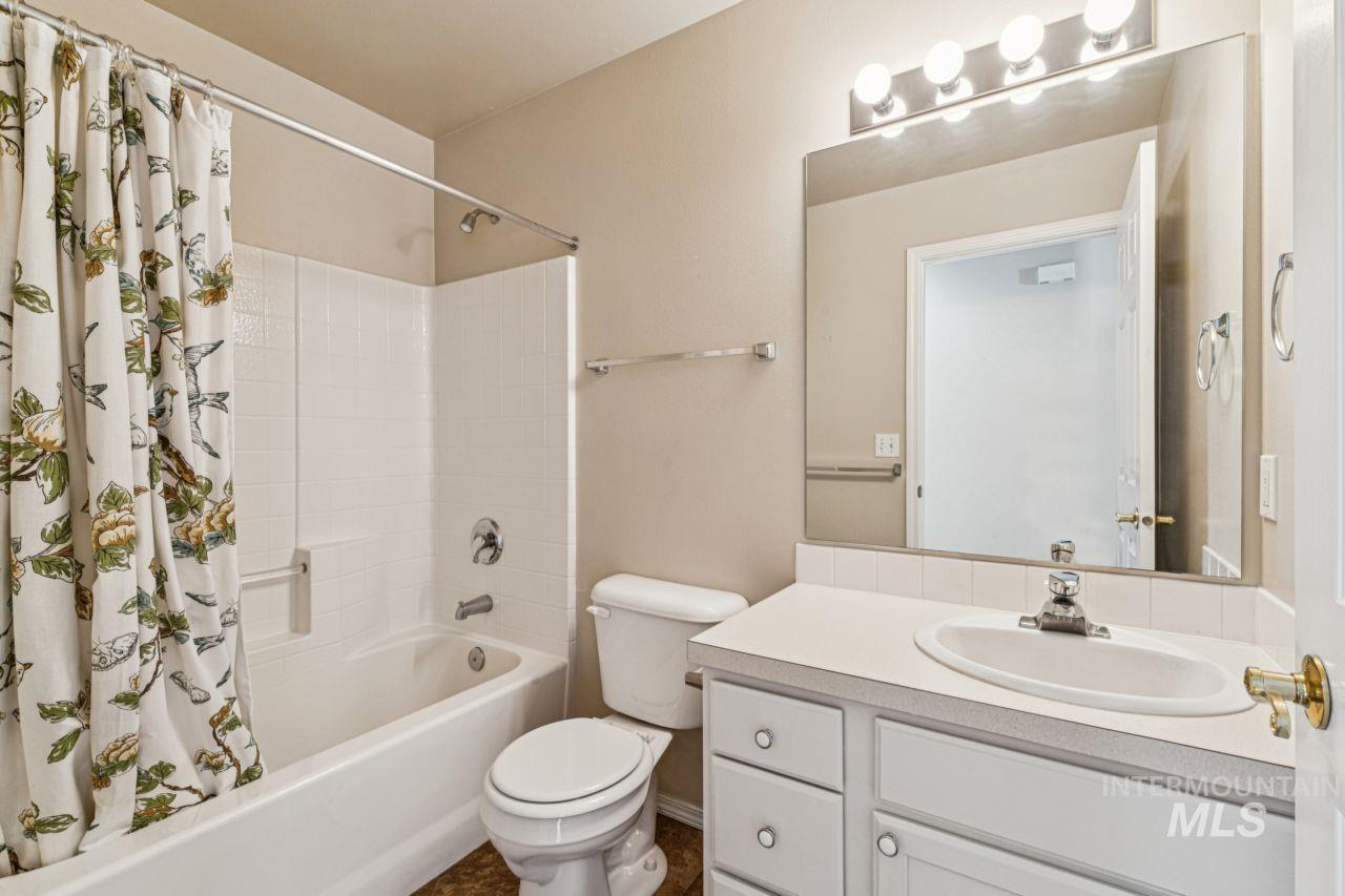 Full bathroom with shower / bath combo and vanity