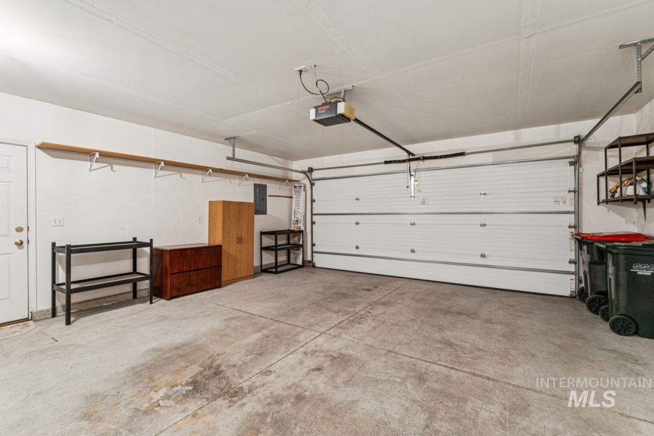 Garage with electric panel and a garage door opener