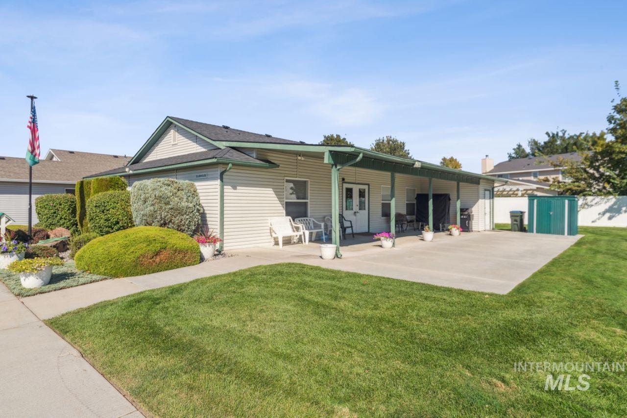 Rear view of house featuring a yard and a patio area