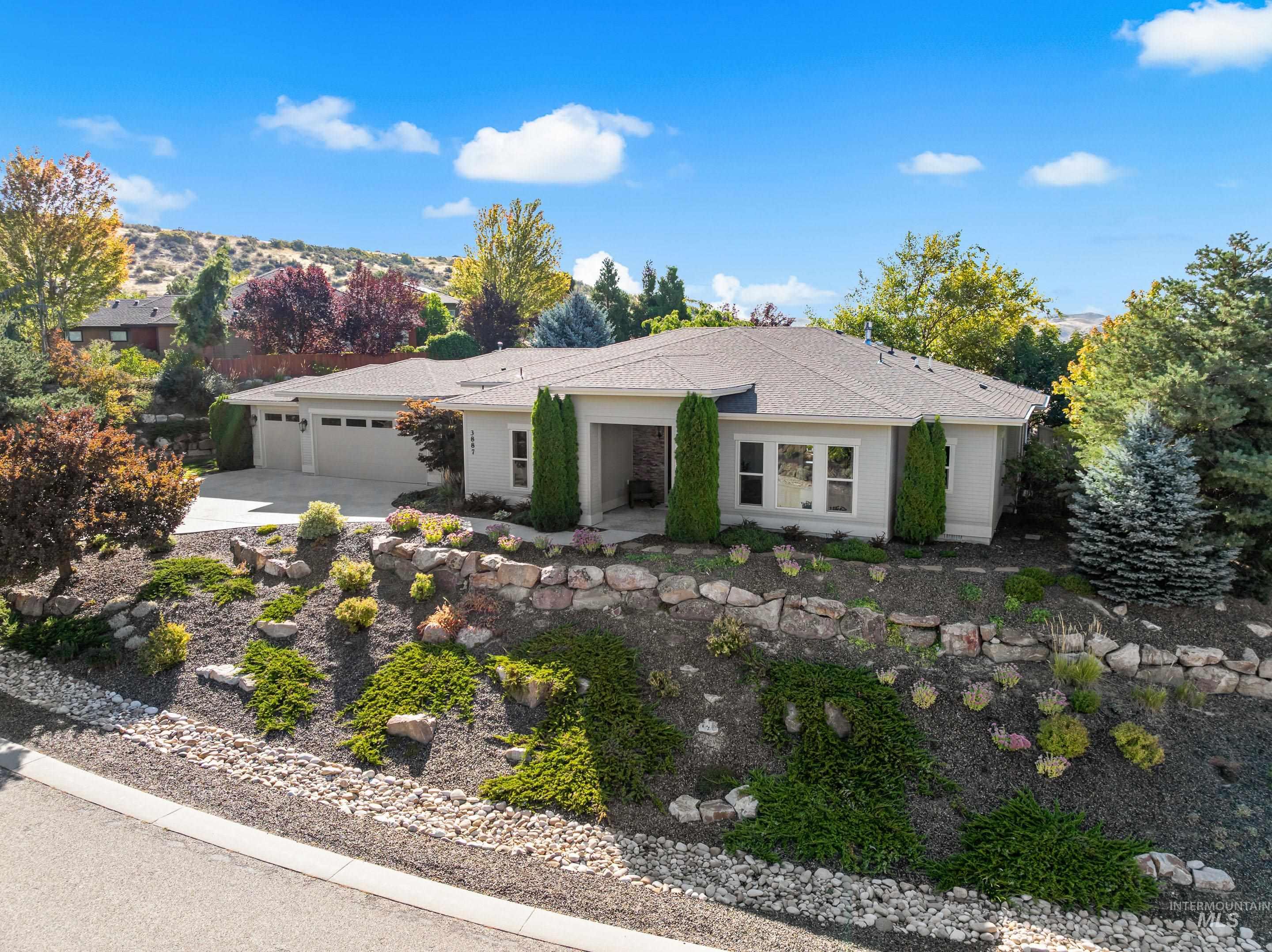 Ranch-style home featuring driveway and an attached garage