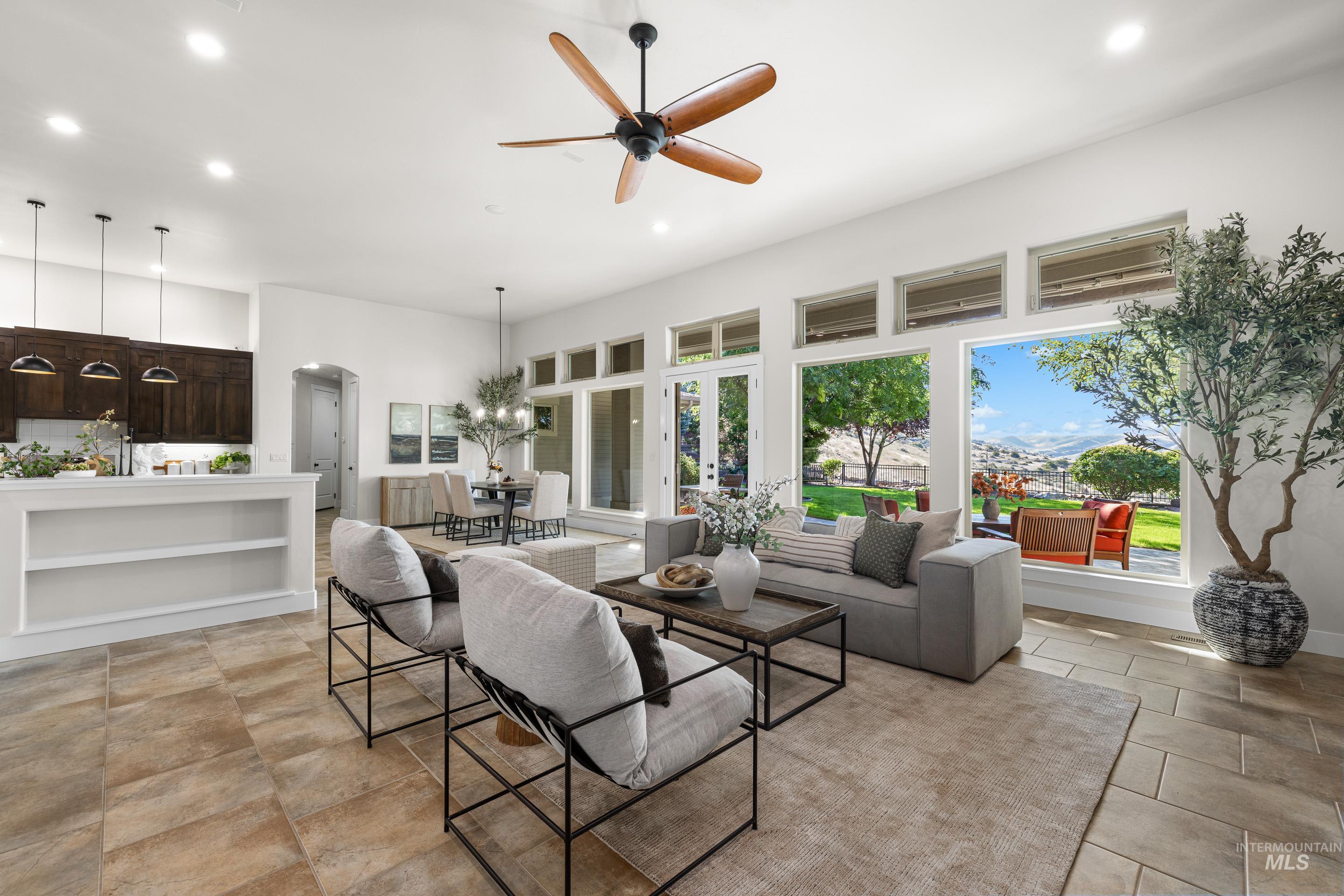 Living area with recessed lighting, ceiling fan, a chandelier, and arched walkways