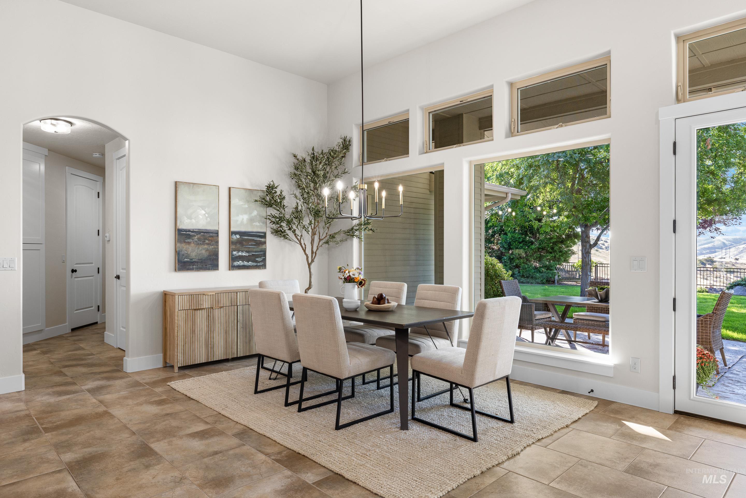 Dining area with arched walkways and plenty of natural light