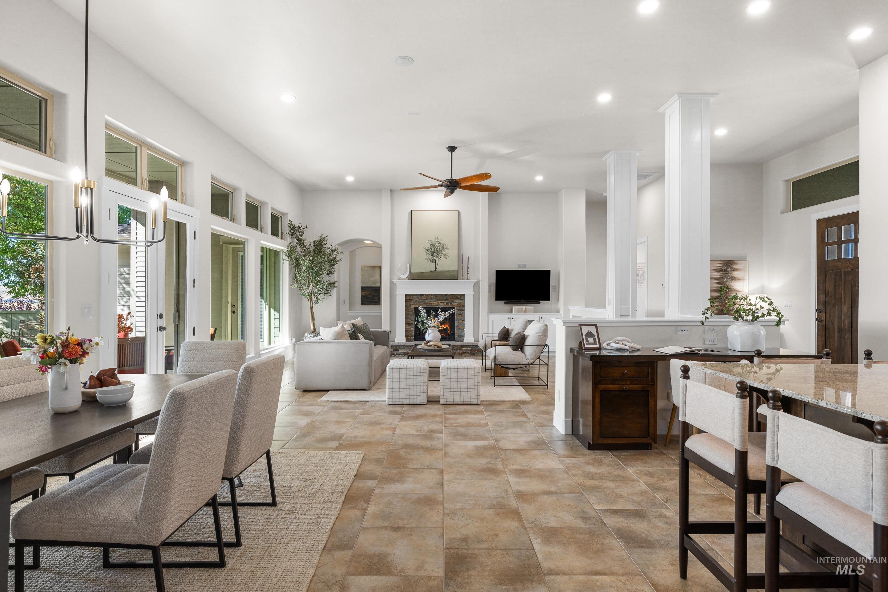 Dining space featuring a fireplace, recessed lighting, ceiling fan, and healthy amount of natural light