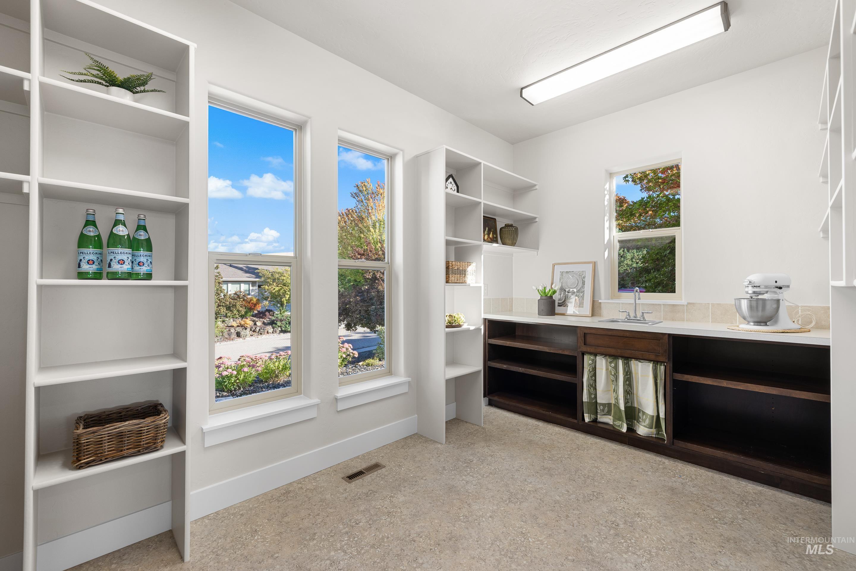 Office area featuring dark aggregate flooring and baseboards