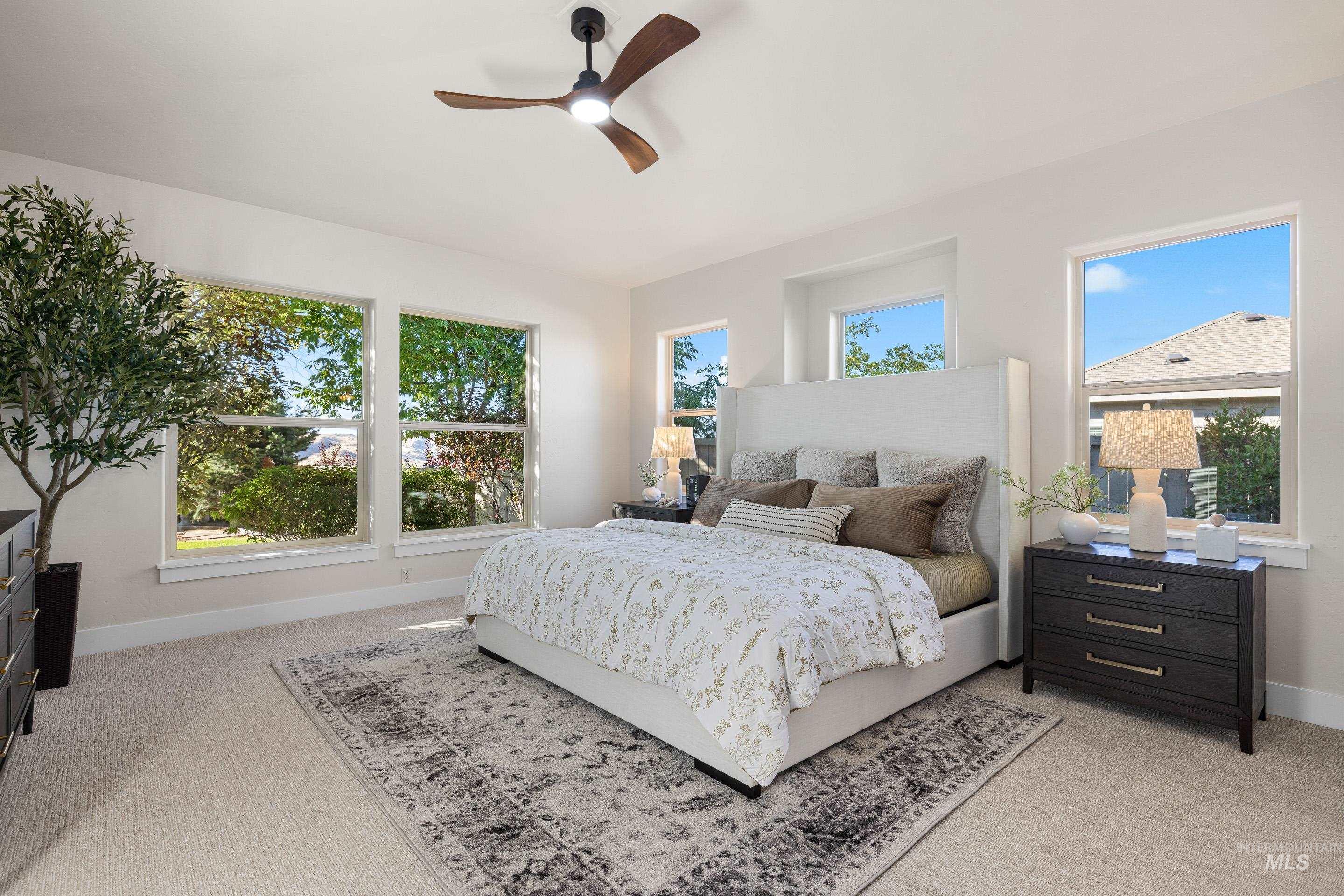 Bedroom featuring light colored carpet and a ceiling fan