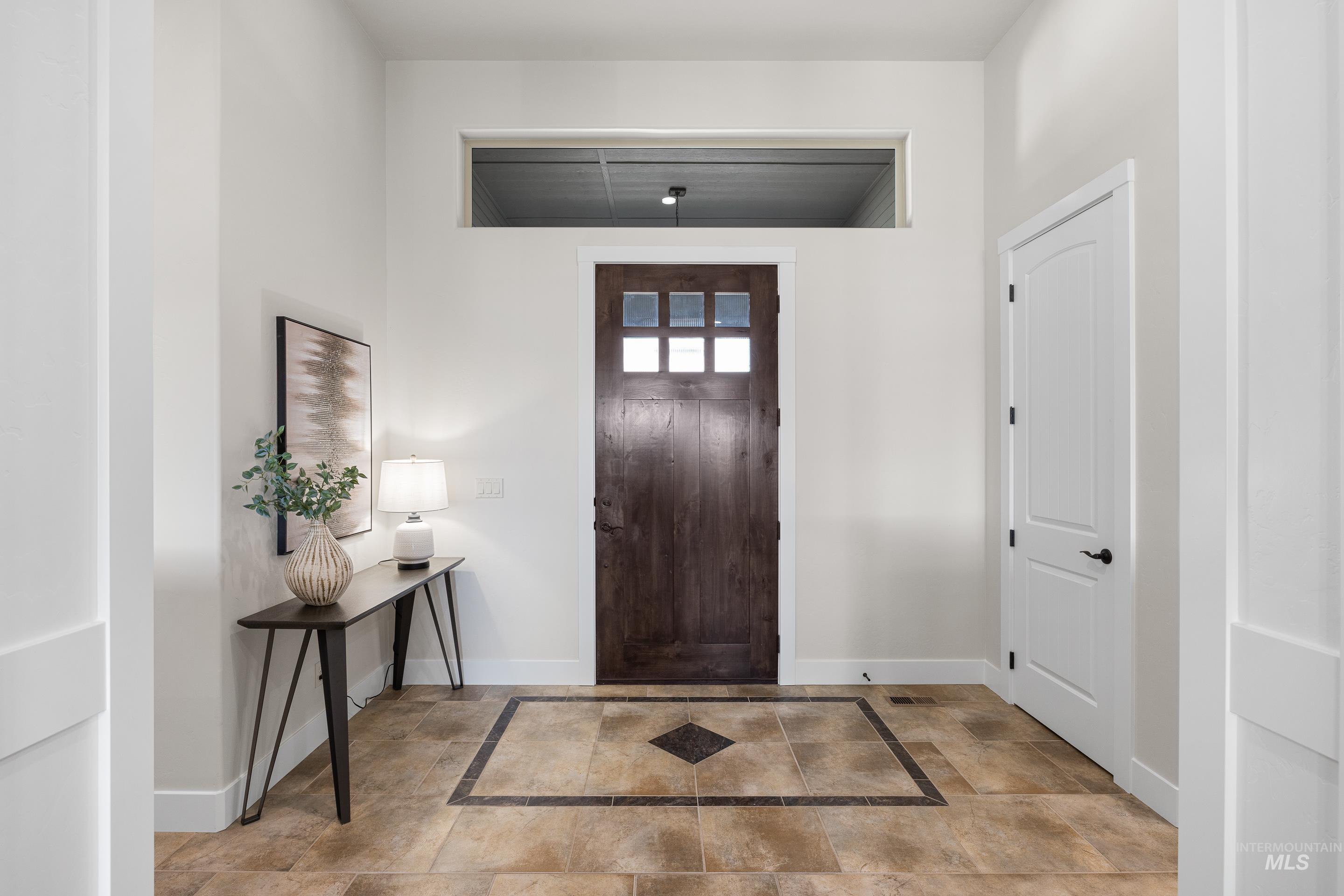 Foyer featuring baseboards and inlaid floor details