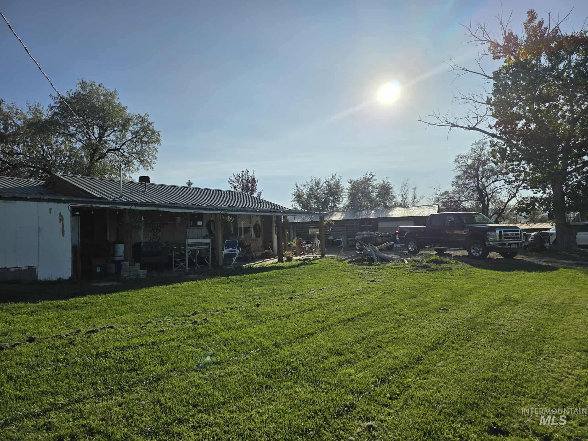 View of green lawn featuring a patio area