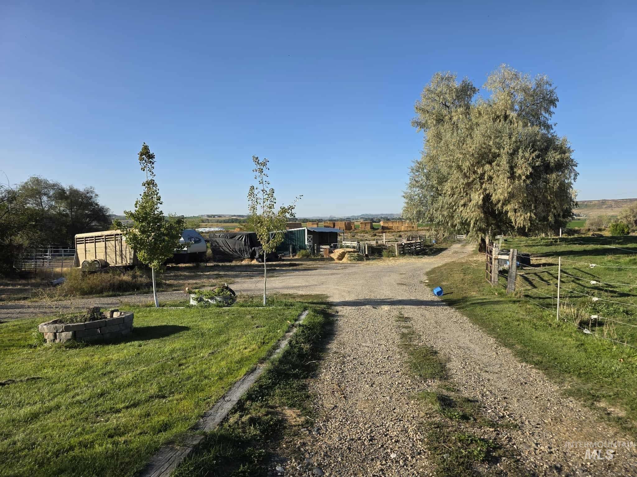 View of dirt / gravel driveway featuring a view of countryside