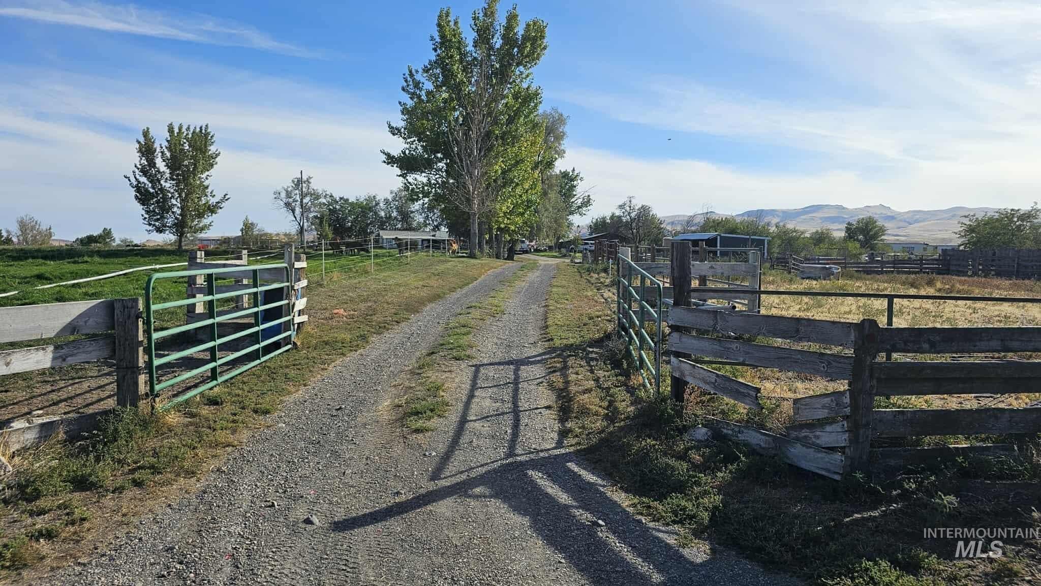 Gate featuring a rural view and a mountain view