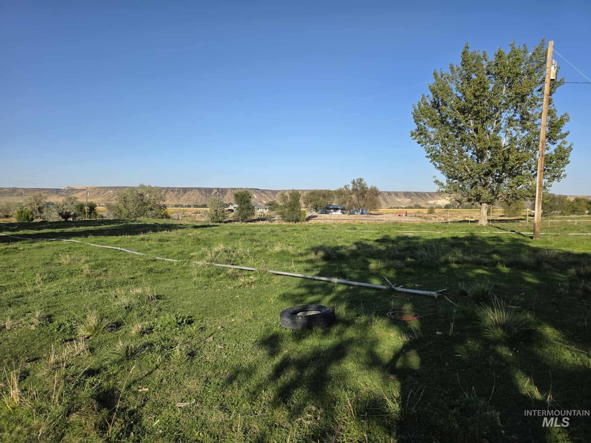 View of green lawn with a rural view