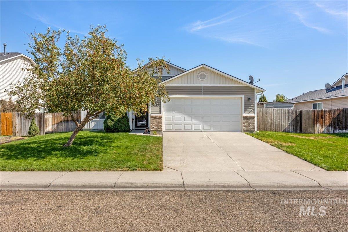 Spacious driveway and lush front yard welcome you home.