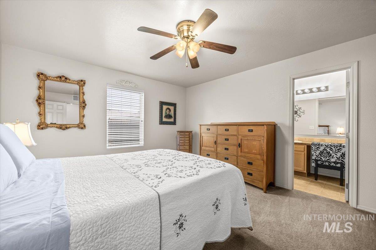 Bedroom with light carpet and ceiling fan