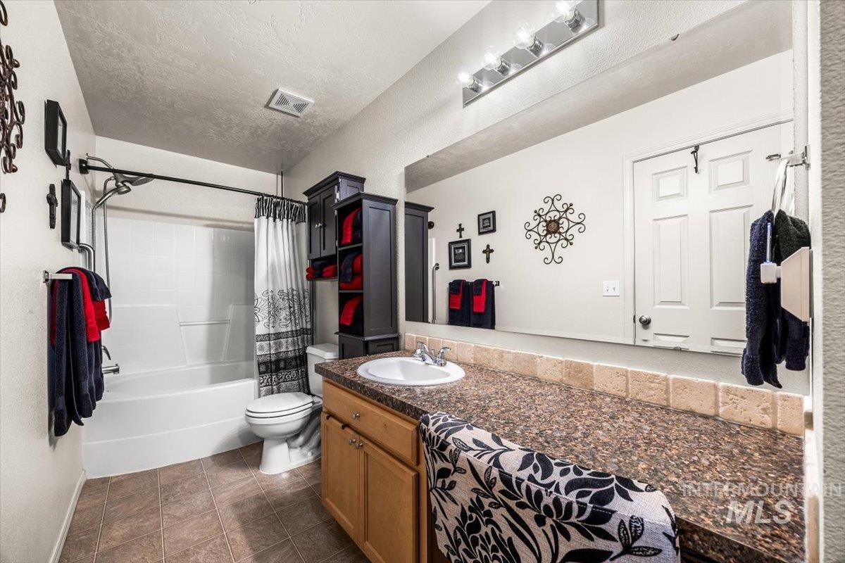 Full bath with shower / bath combination with a vanity and makeup area.