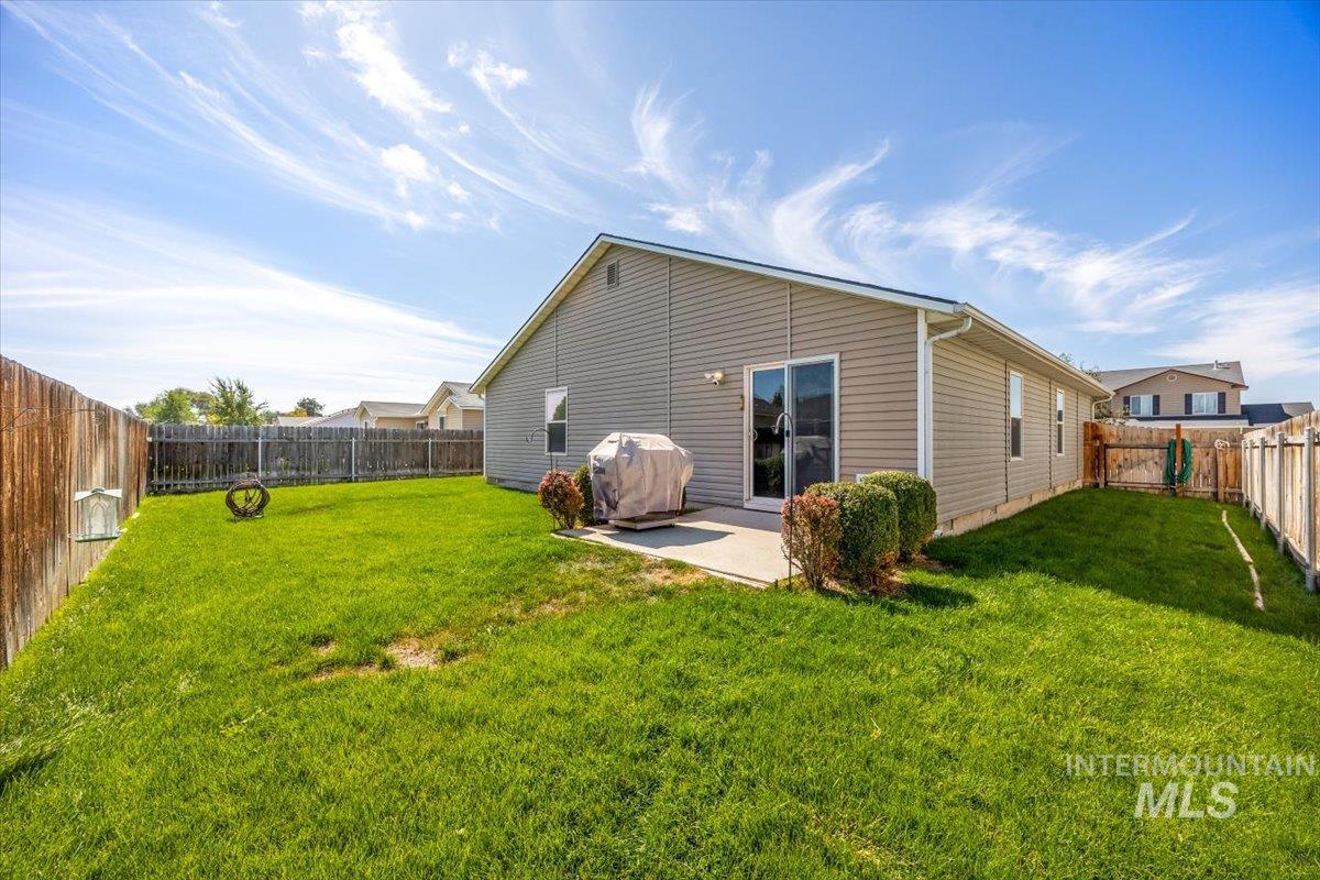 Spacious fully fenced backyard with a patio, perfect for outdoor gatherings and pets.