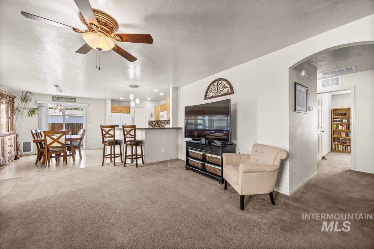 Seamless flow from living room to dining and kitchen.