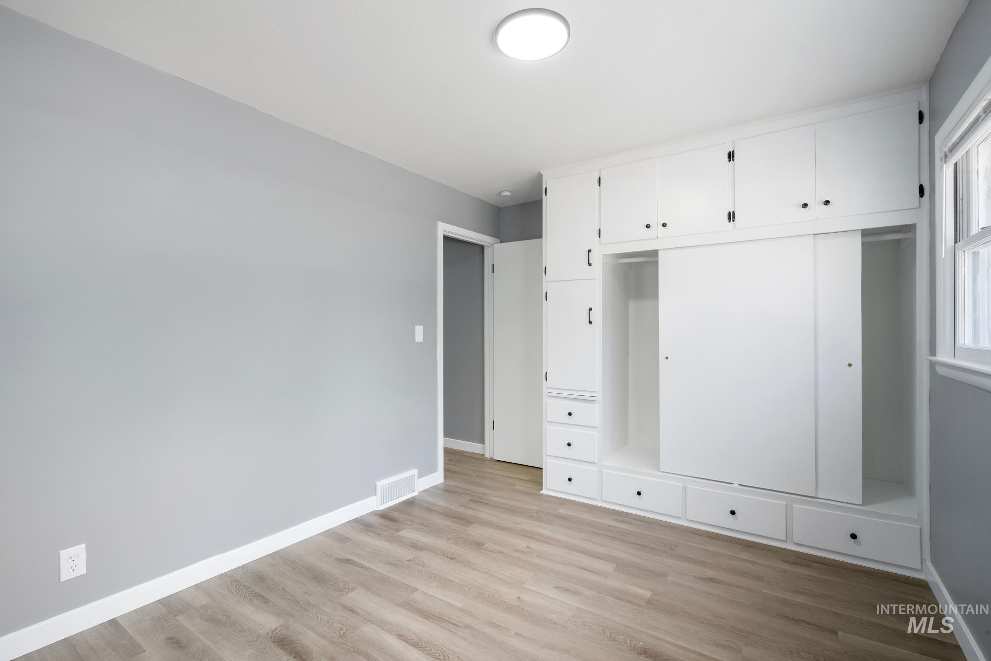 Mudroom featuring baseboards and light wood-style floors