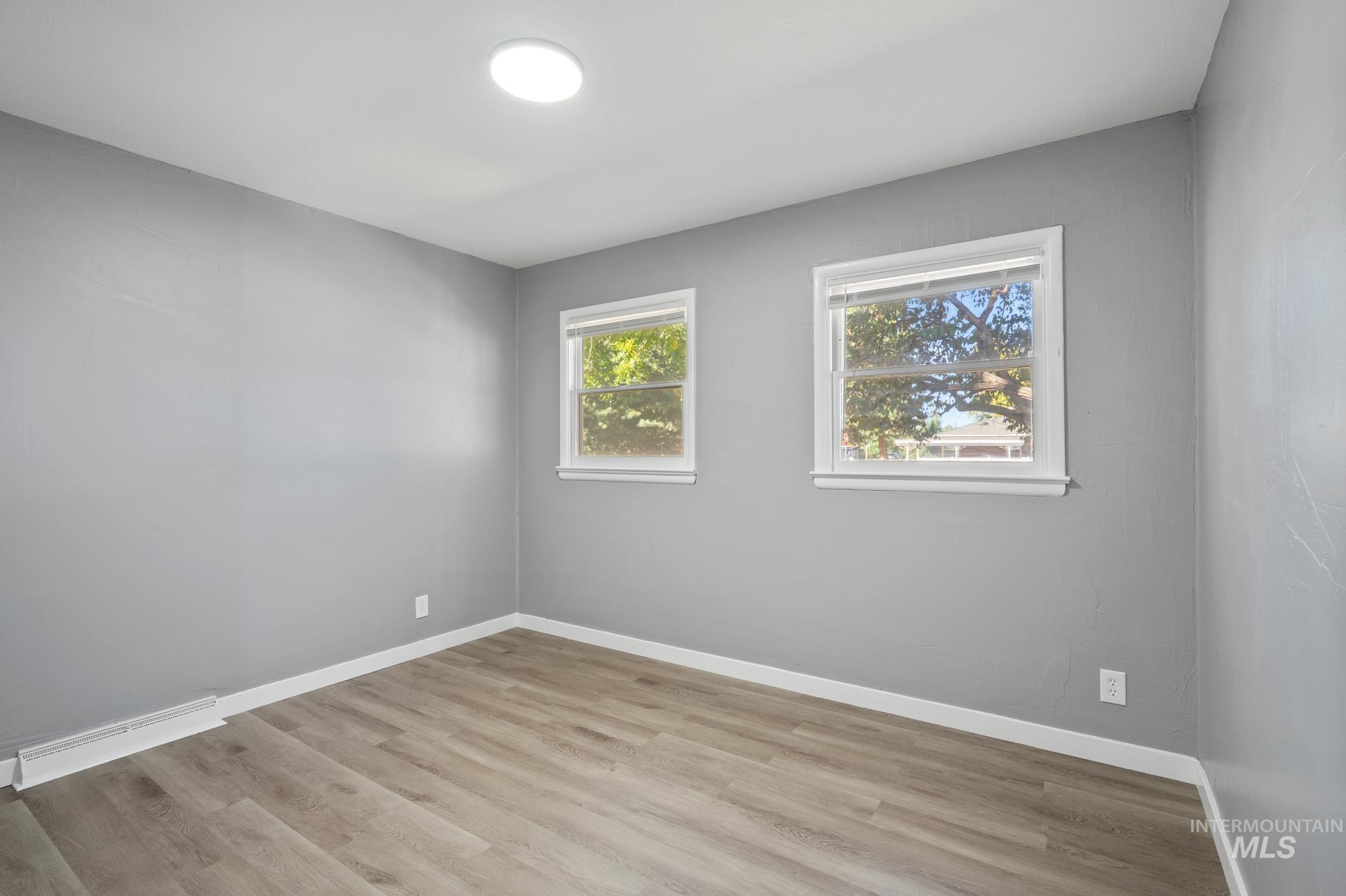 Unfurnished room with light wood-style flooring