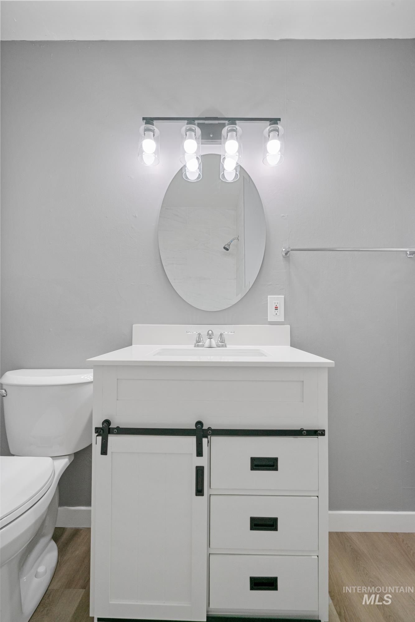 Bathroom with vanity and light wood-type flooring