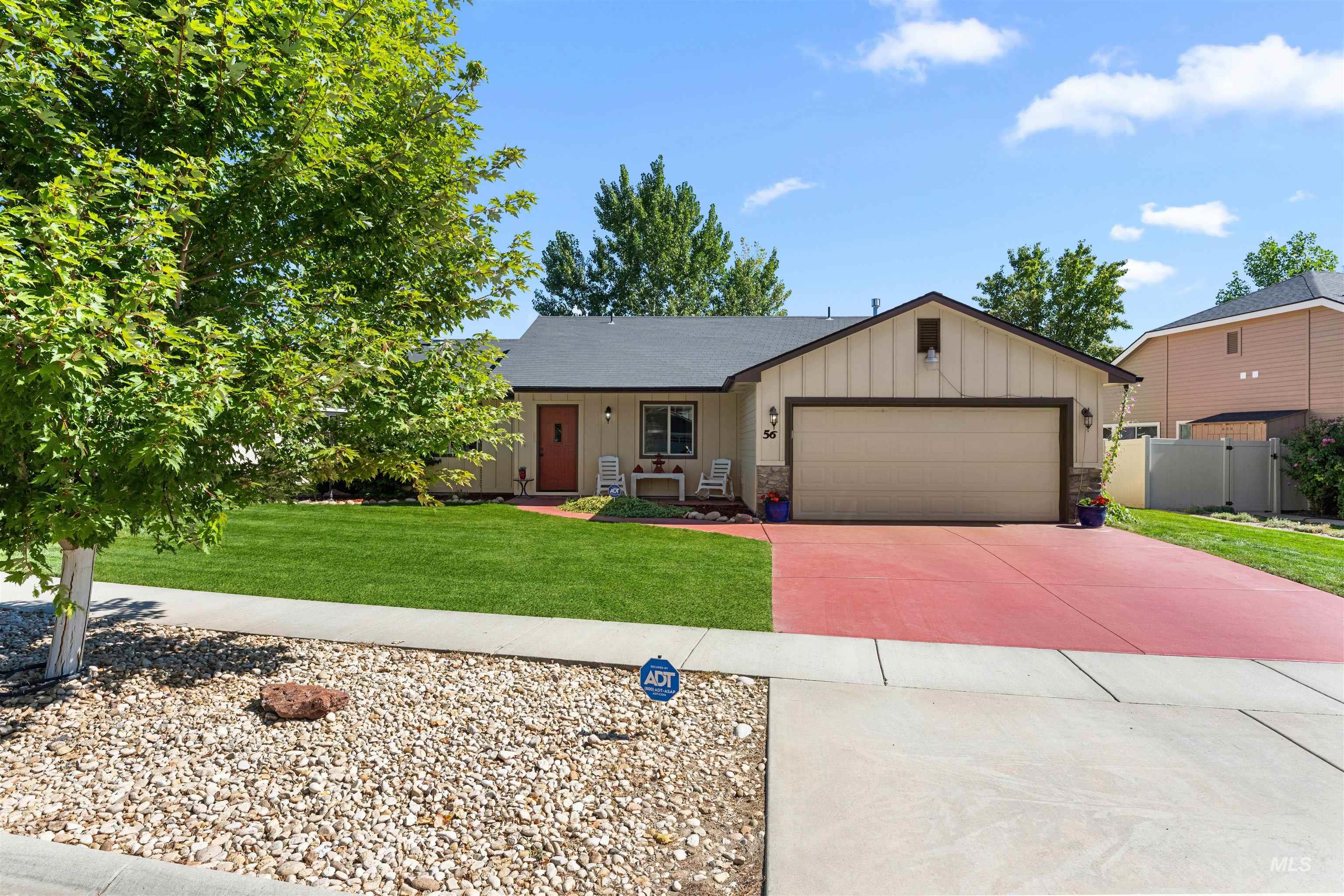 View of front of house with board and batten siding, concrete driveway, and a garage