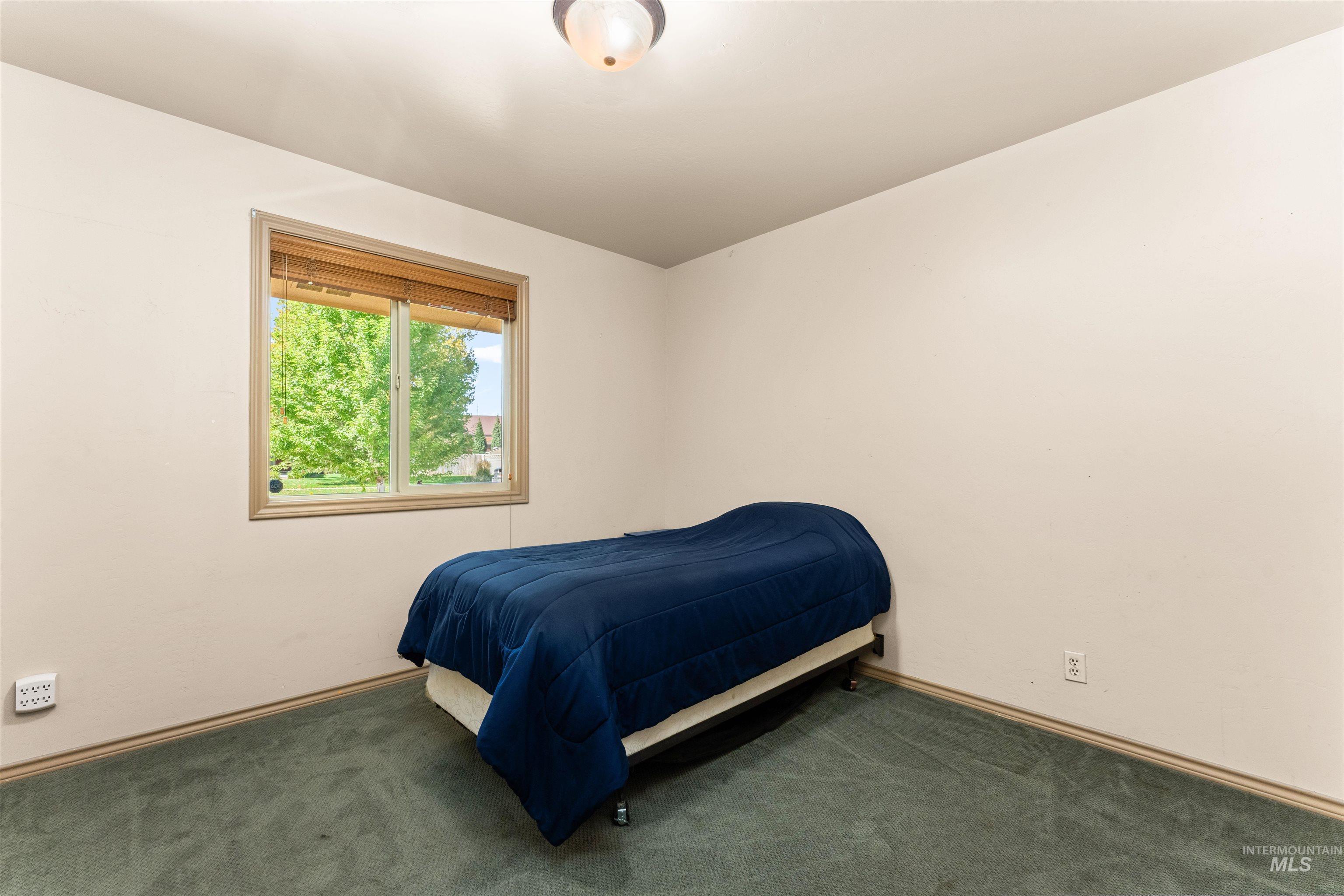 Carpeted bedroom with baseboards