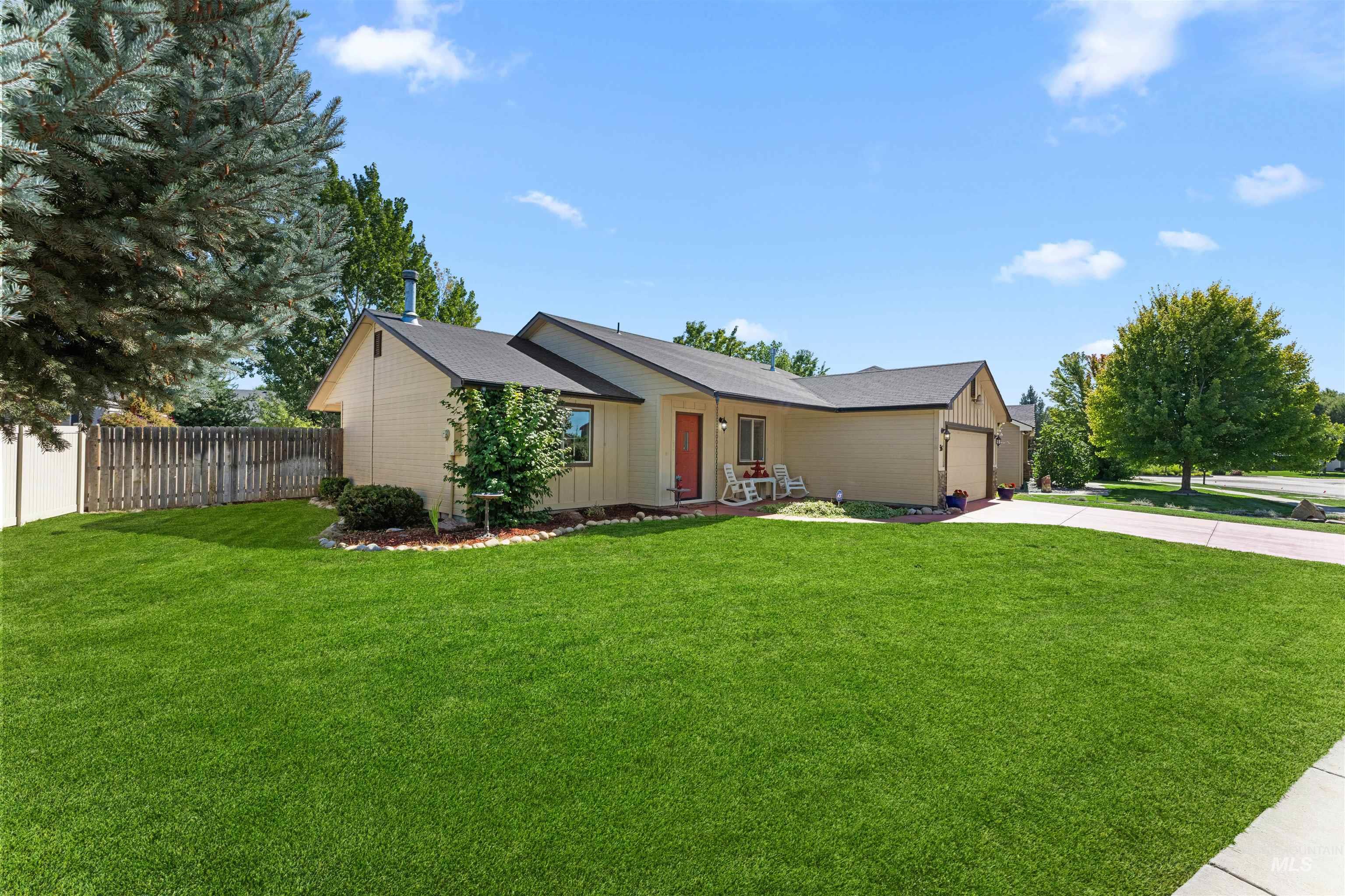 Ranch-style home featuring driveway, a garage, and a shingled roof