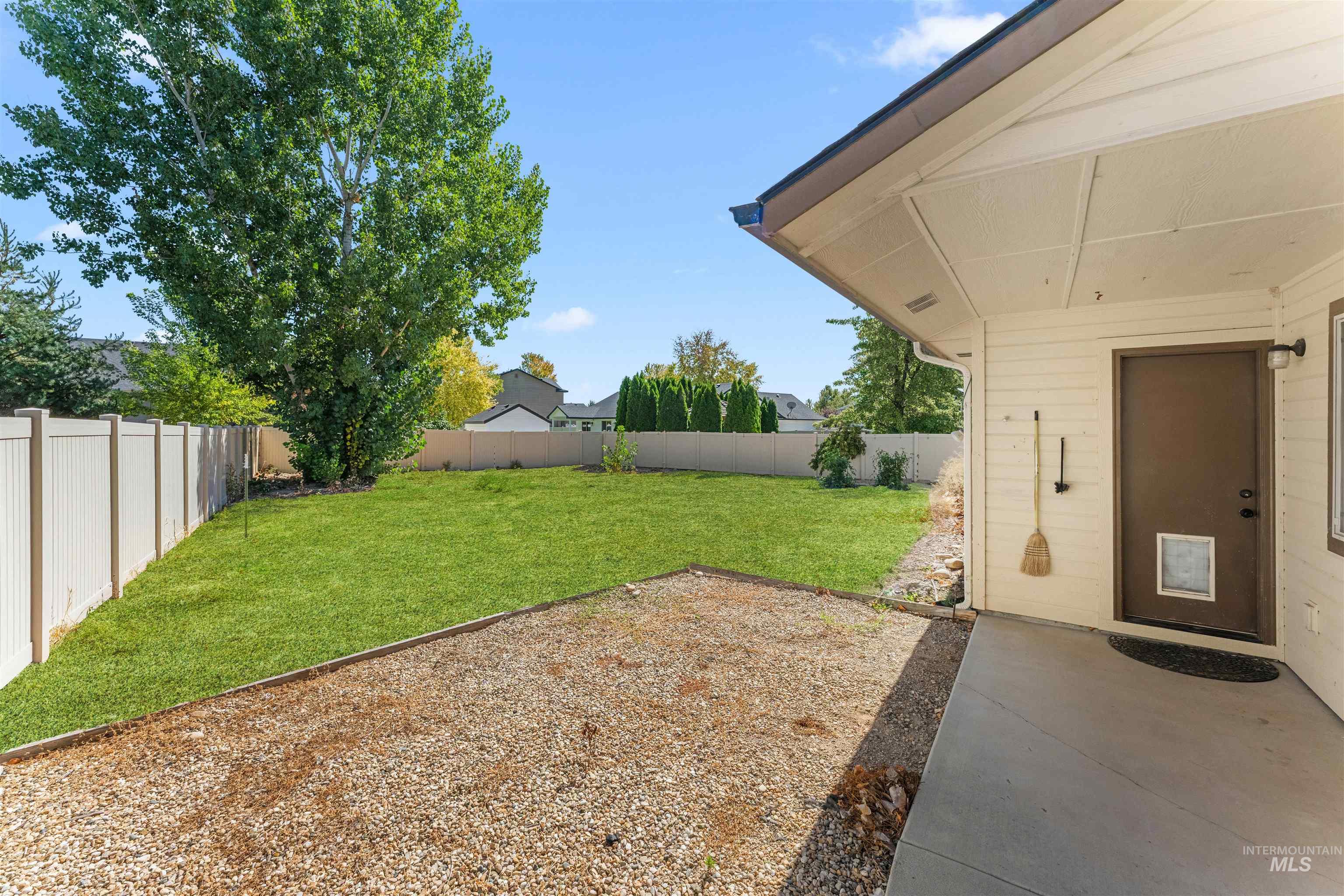 Fenced backyard featuring a patio