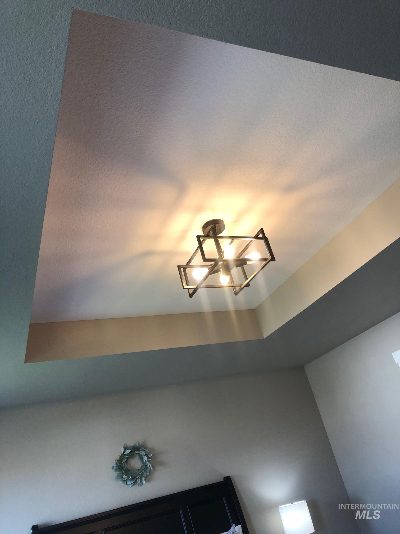 Detailed view of a tray ceiling and a chandelier