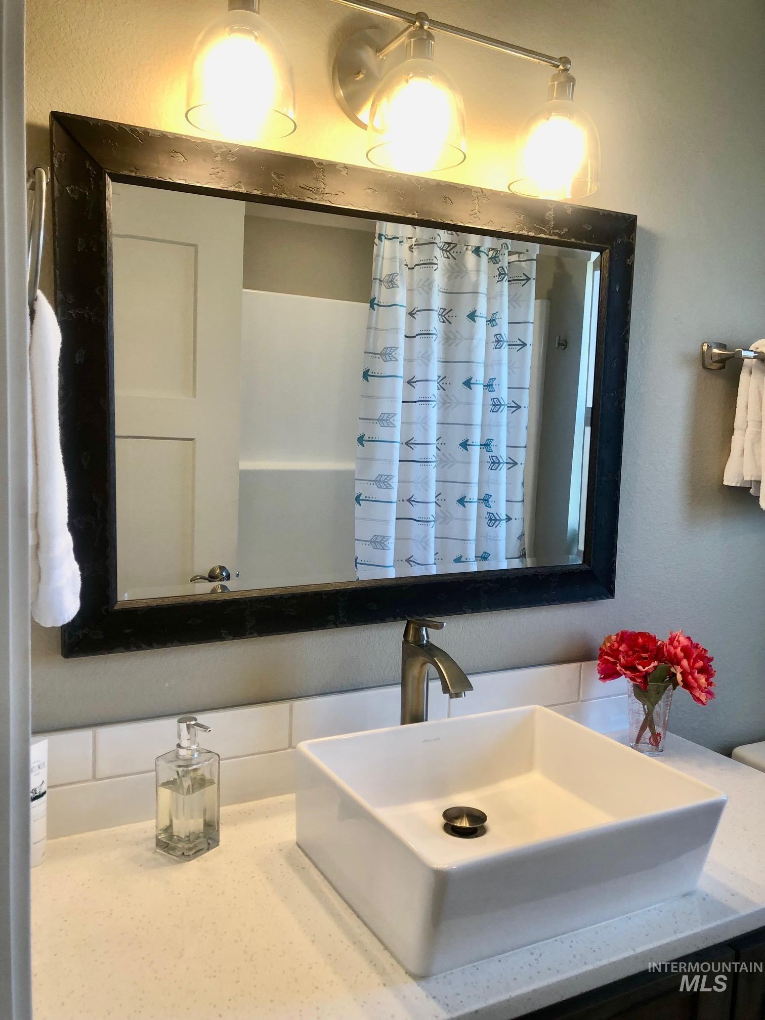 Bathroom featuring vanity and a textured wall