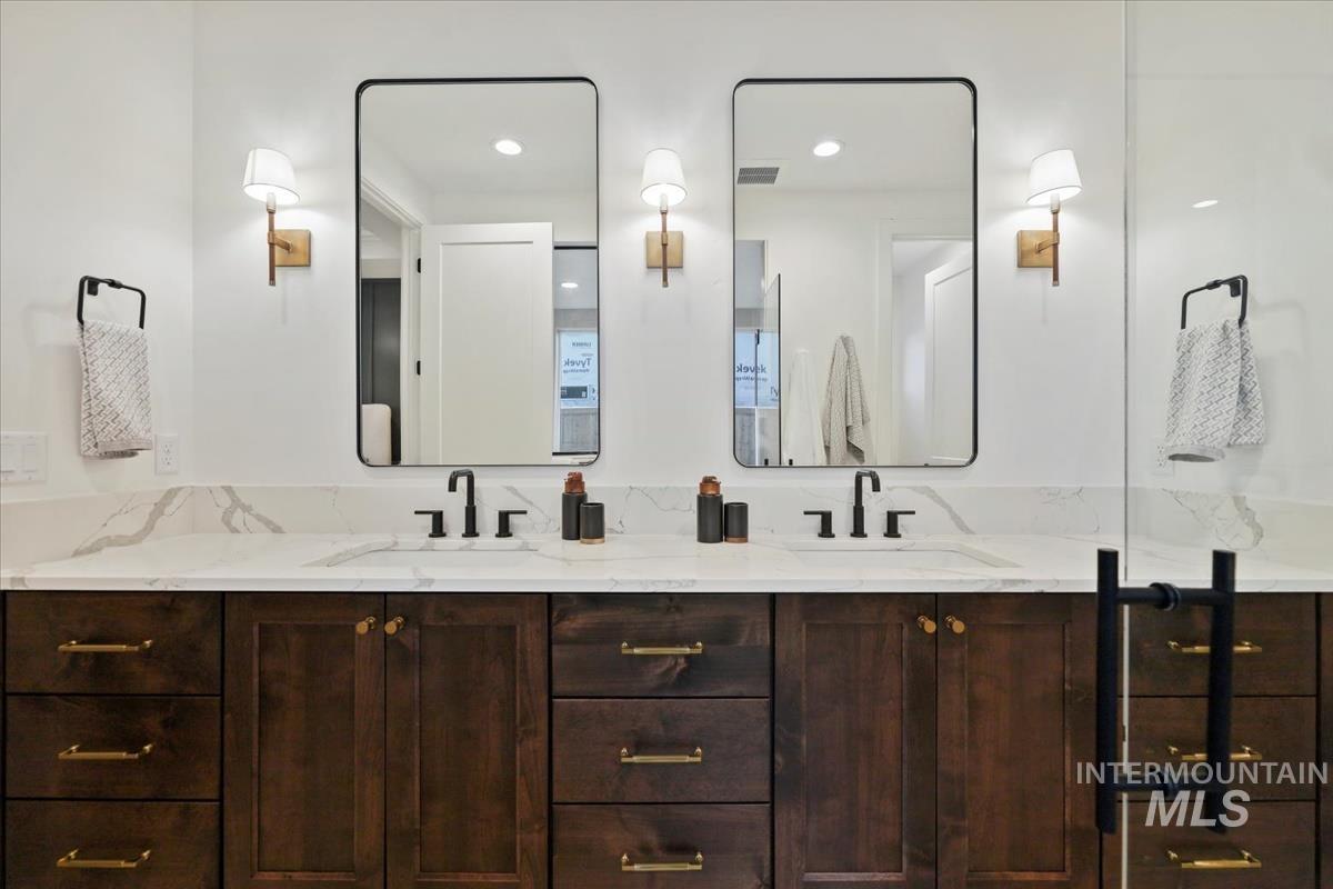 Full bath with double vanity and recessed lighting