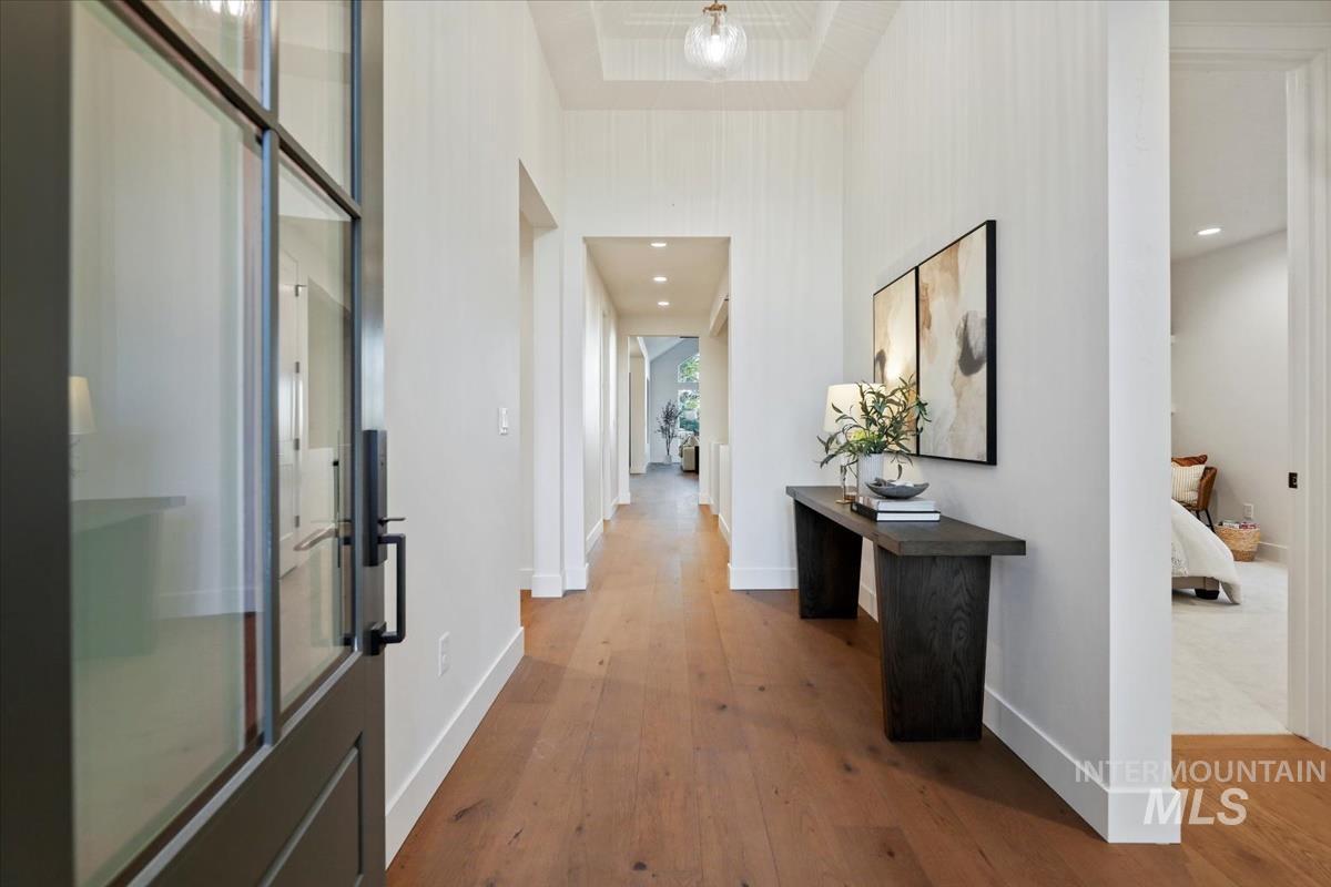 Hallway featuring light wood finished floors and baseboards
