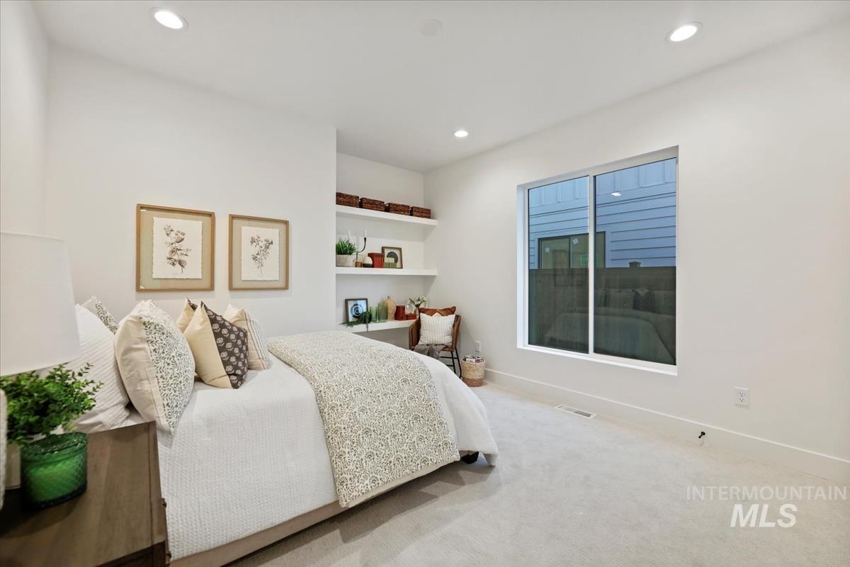 Carpeted bedroom with recessed lighting and baseboards