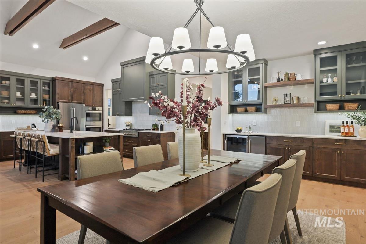 Dining area featuring light wood-style floors, recessed lighting, and a chandelier